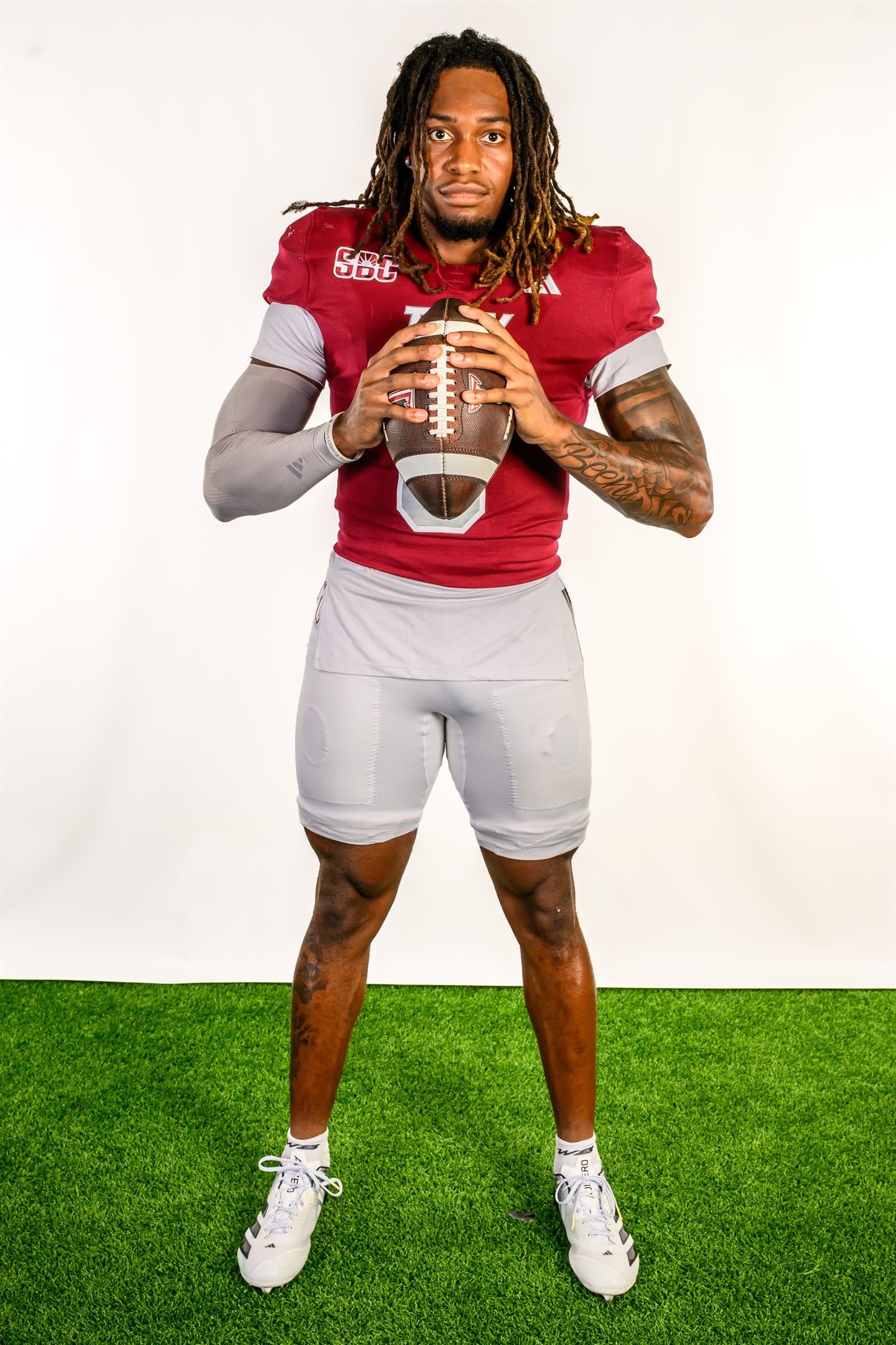 Justin Powe #06 — holding football, Troy uniform