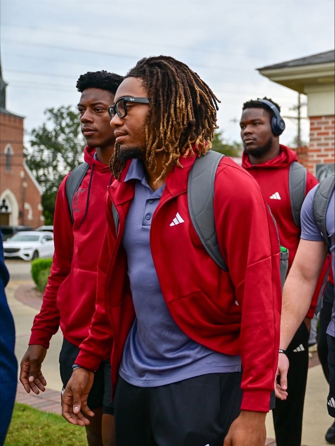 Justin Powe and Troy teammates walking in red Adidas gear
