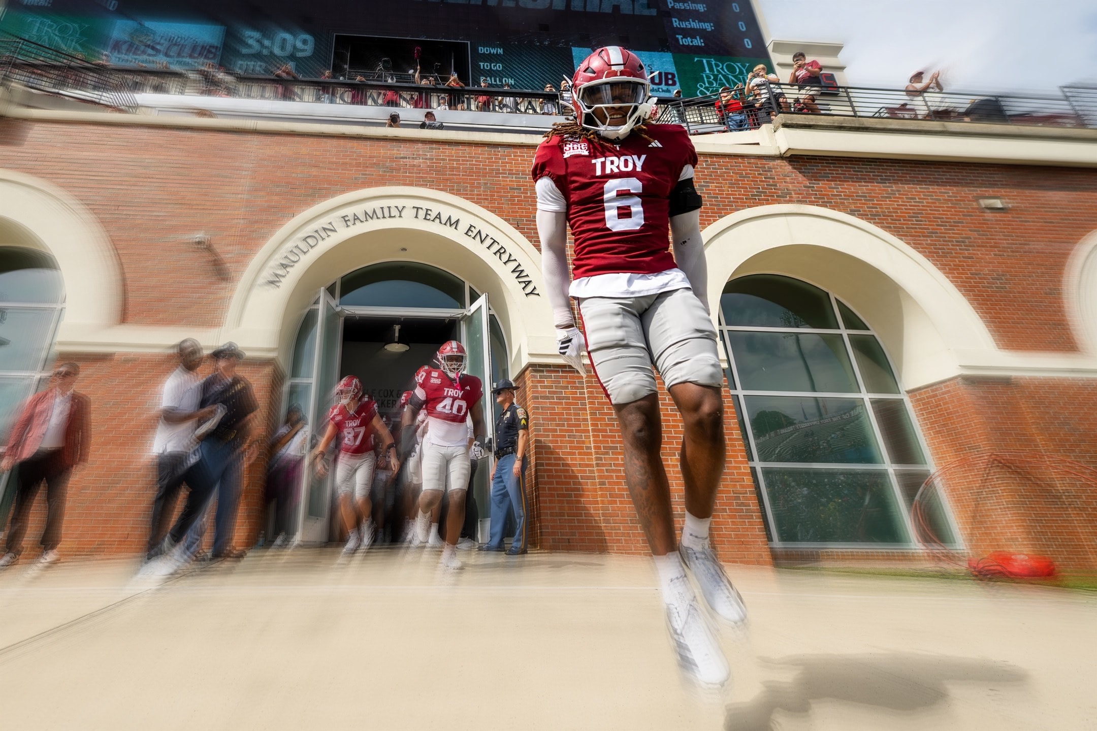 Justin Powe #6 leaping out of the Troy stadium tunnel entrance