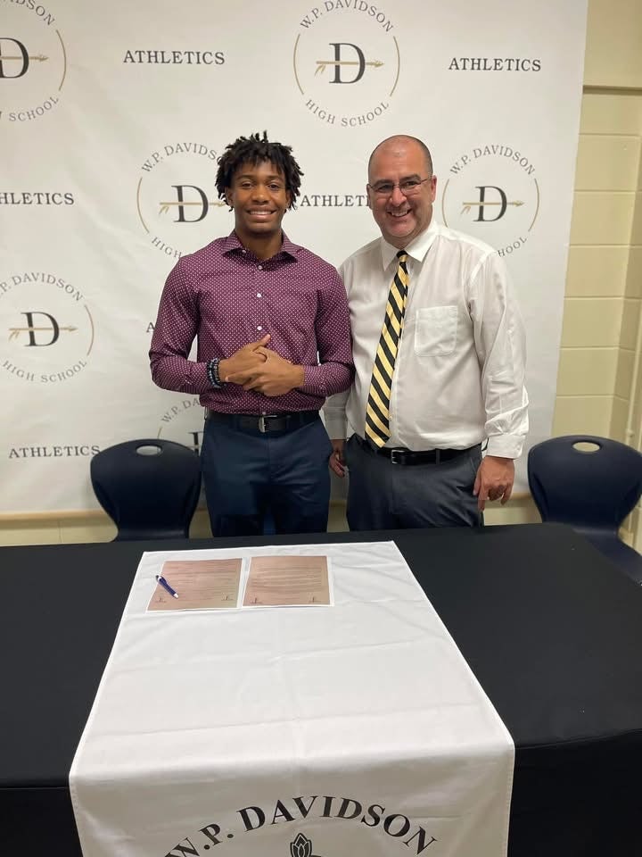 Justin Powe scholarship signing day at W.P. Davidson High School Athletics